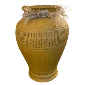 Rustic mustard yellow pottery vase with carved band detail.